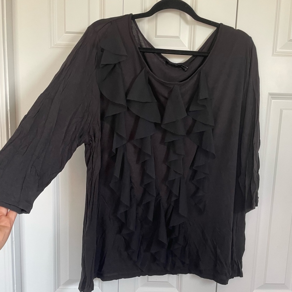 Woman’s black ruffled blouse